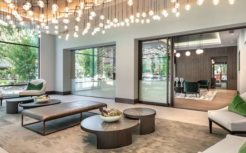 beautiful lighting grid hangs above lounge area in resident center