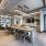 open kitchen with ample lighting and island seating in resident lounge
