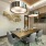large table surrounded by chairs in bright conference room with mounted television