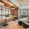 various work spaces in business lounge with floor-to-ceiling wall of windows