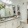 large, brightly lit vanity counter with sink in bathroom with walk-in closet