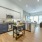 open kitchen next to living room with recessed and under cabinet lighting