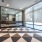 ballet bars against mirrored wall in workout studio with large, bright windows