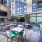 grilling area in outdoor lounge with fireplace seating, eating area and wall mounted tv