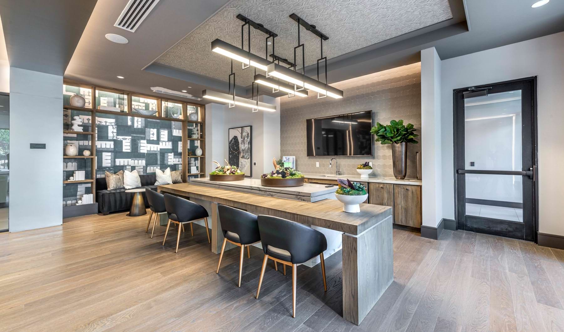 Style & Class open kitchen with ample lighting and island seating in resident lounge